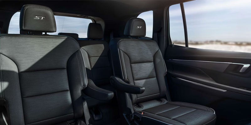 2026 Buick Enclave interior in Quincy IL showing three-row seating, SynTex and leather-appointed seats, and panoramic sunroof