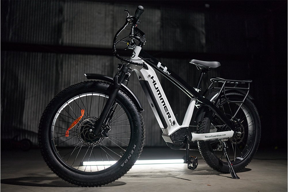 The AWD Electric Bike is parked inside the container.